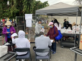 Photo of volunteers handing out supplies to those in need at a community event