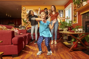 Photo of a family dancing in a living room