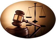 Picture of a judge's gavel in front of a silhouette of the scales of justice