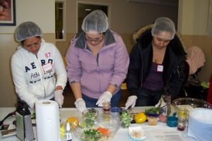 Photo of Cooking for Health Academy staff prepping food.