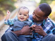 An image of a dad holding his infant. 